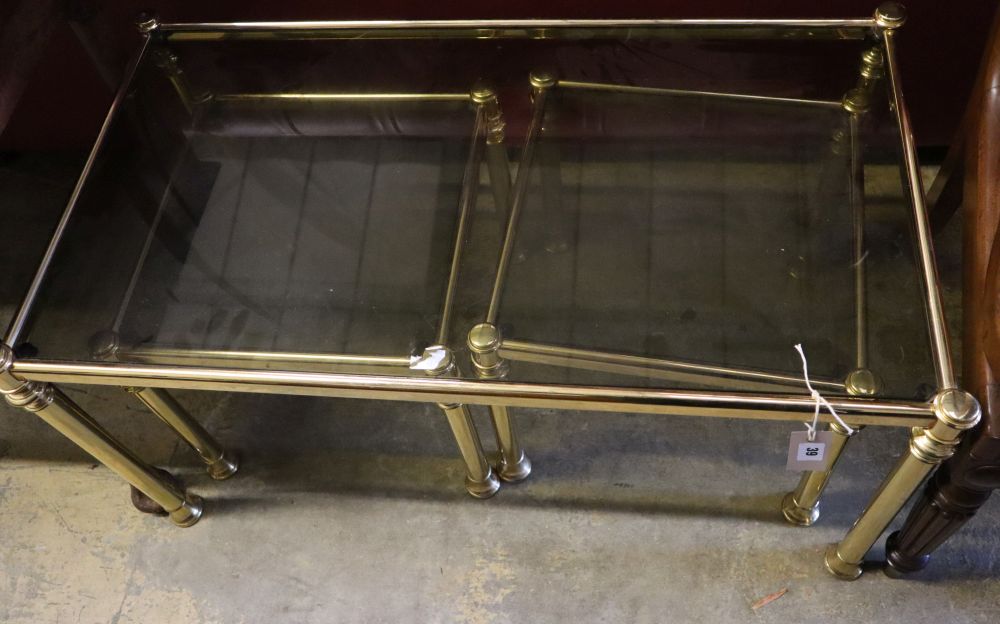 A nest of three brass and smoked glass tea tables, width 90cm depth 50cm height 44cm